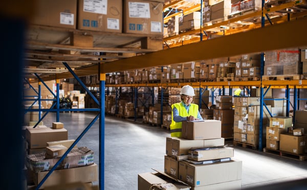 warehouse worker with a stack of boxes